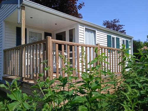 a house with a wooden deck in the yard at Olydea le Lambon - Prailles-la-Couarde in Prailles