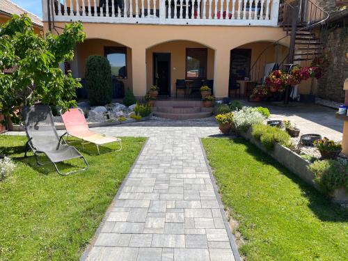 a patio with a bench in the yard of a house at apartmánový dom Magda in Vrbov