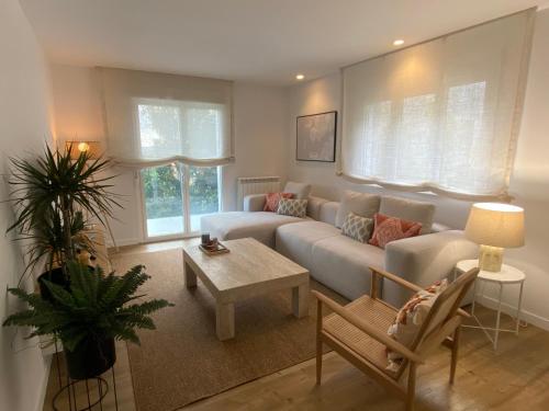 a living room with a couch and a table at Prado Essence in Sanxenxo