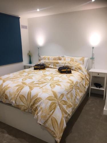 a bedroom with a bed with two bags on it at Stylish Apartment, Beach & Town 2 min walk in Bournemouth