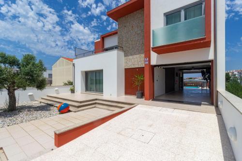 an image of a house with a patio at O CANTINHO ENTRE A RIA E O MAR - with hot water pool all year round in Torreira