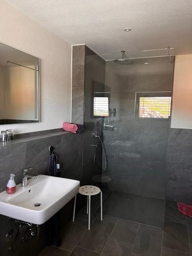 a bathroom with a sink and a shower at Weingut & Straußwirtschaft Vogel in Vogtsburg