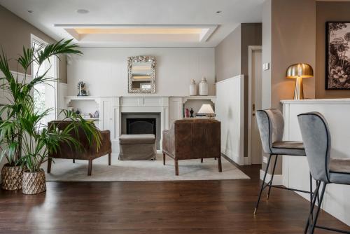 a living room with a fireplace and a chair at Hotel Maestrale in Riccione