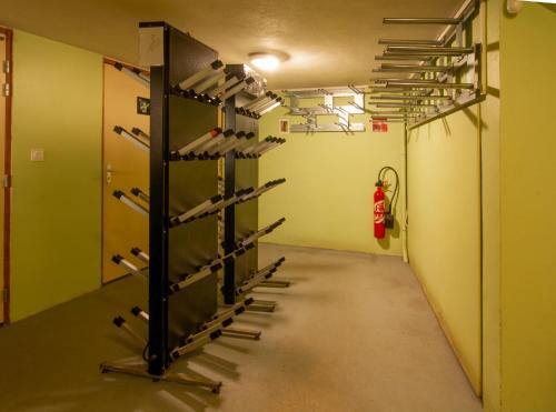 a room with a row of racks of weights at Chalet Hotel La Tarine in Peisey-Nancroix