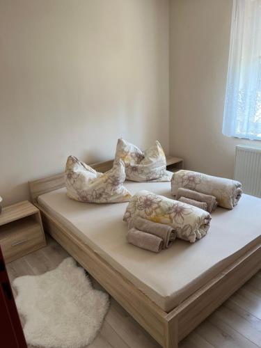 a bed with pillows on it in a room at apartmánový dom Magda in Vrbov