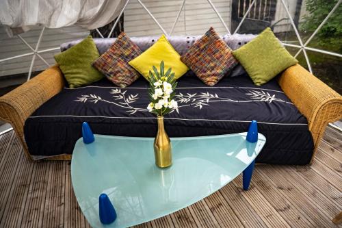 a couch and a table with a vase on it at Villa ROYAL CLUB 13 in Jūrmala