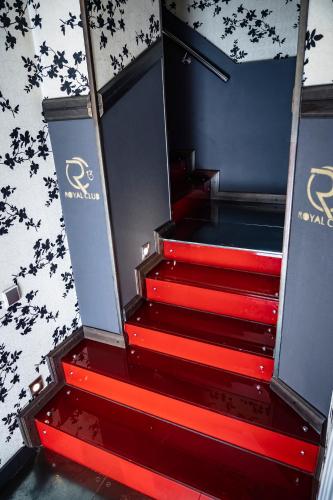a set of red stairs in a room with a wall at Villa ROYAL CLUB 13 in Jūrmala