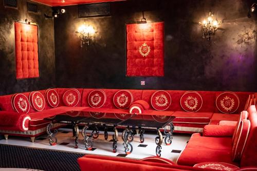 a red couch in a theatre with red walls at Villa ROYAL CLUB 13 in Jūrmala
