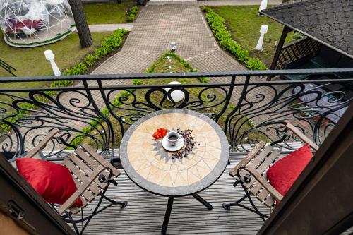 a table and two chairs on a balcony at Villa ROYAL CLUB 13 in Jūrmala