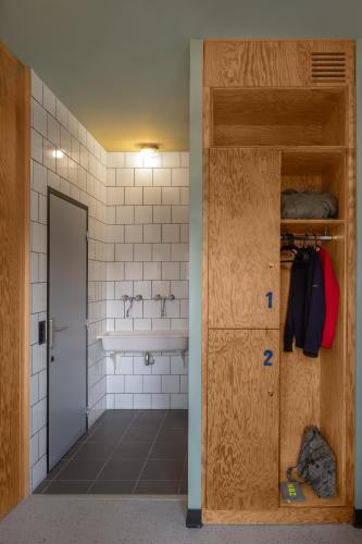 a bathroom with a toilet and a sink and a door at Eklo Clermont Ferrand Centre Gare in Clermont-Ferrand