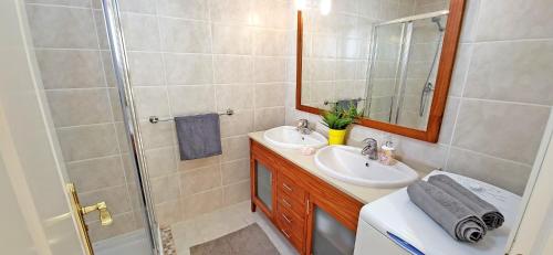 a bathroom with a sink and a shower at CASA LOTTA in Costa Calma