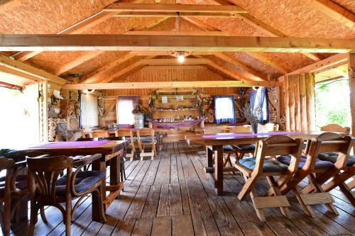 a dining room with wooden tables and chairs at Lavanda farm apartmani in Rakovica