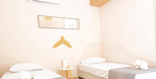 two beds in a room with white walls at Haroupia The Residence in Kalidhón