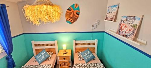two twin beds in a room with blue walls at CASA BALIMAR in Tarajalejo