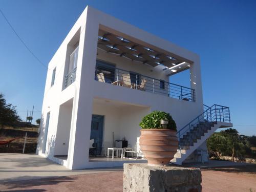 a white house with a planter in front of it at Theros house in Kýthira