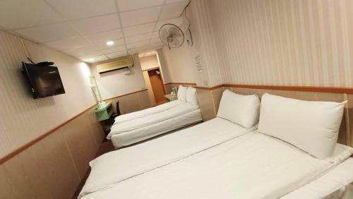Postel nebo postele na pokoji v ubytování Ying Lun Hotel