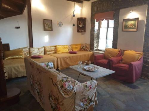a living room with a couch and a table at Το Πέτρινο Αρχοντικό in Afissos