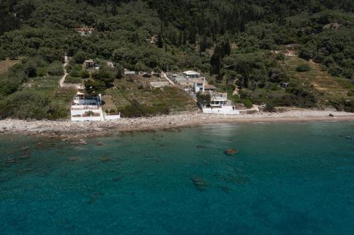 an aerial view of a beach with houses and the ocean at Villa Renata & Villa Filippos with private Plunge Pool by Konnect in Agios Gordios