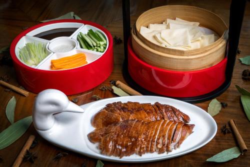 a plate of food with meat and vegetables on a table at Shangri-La Dubai in Dubai