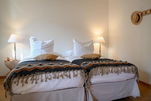 a bedroom with a bed with two pillows on it at Hameau d'Eguisheim in Eguisheim