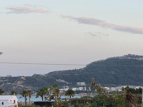 a view of the ocean and a mountain at 12 senses faliraki sea view in Faliraki