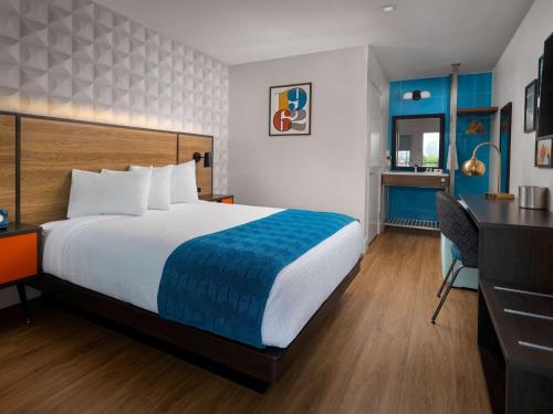a hotel room with a bed and a desk at Motel 6-Santa Barbara, CA - Beach in Santa Barbara