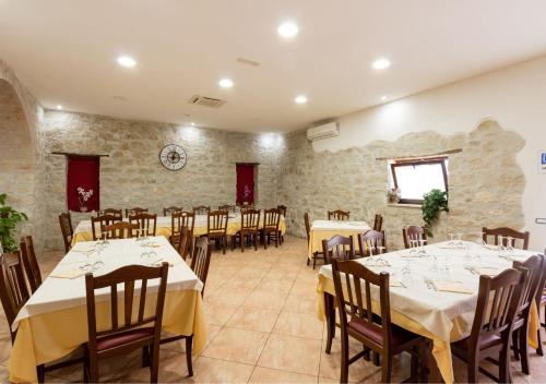 a dining room with tables and chairs in it at Agriturismo in montagna in Irpinia in Castelfranci