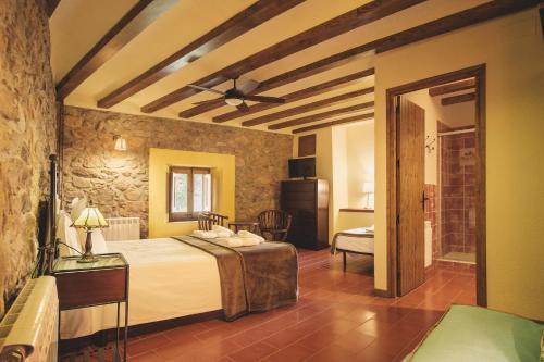 a bedroom with a large bed in a room at Agroturismo Mas Vilar, feel at home in Arbúcies