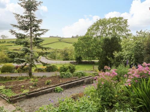 a garden with a view of the rolling hills at Swaledale Watch House Annexe in Wigton