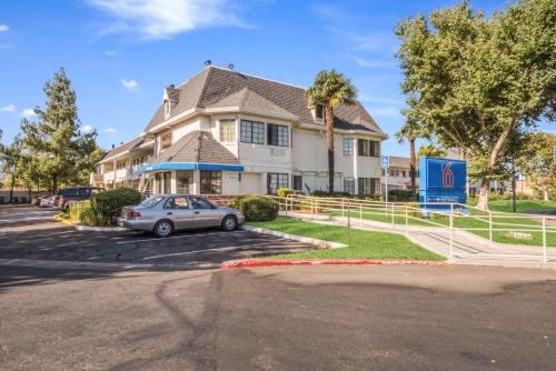 a house with a car parked in a parking lot at Motel 6-Fairfield, CA - North in Fairfield