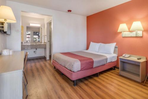 a hotel room with a bed and a kitchen at Motel 6-Fairfield, CA - North in Fairfield