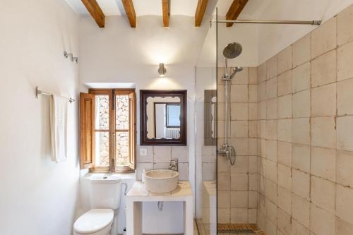 a bathroom with a toilet and a sink and a shower at Can Busquets Apartahotel 2 in Banyalbufar