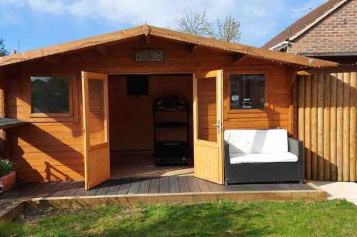a wooden dog house on a deck at Modern 4 bedroom house in Weymouth in Weymouth