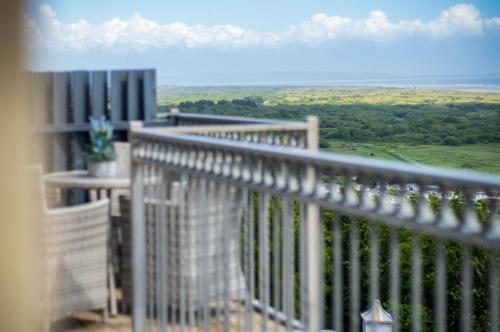 a balcony with a view of the green field at Nautilus - 2 Bedroom Apartment - Pendine in Pendine