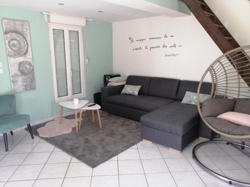 un salon avec un canapé et des chaises dans l'établissement Le temps d'une pause dans l'Yonne, à Charmoy