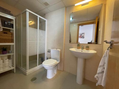 a bathroom with a toilet and a sink and a shower at Sea view pool apartment Mojon hills in Isla Plana