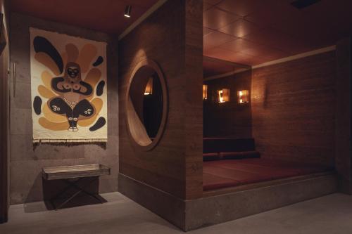 a room with a bathroom with a mirror and a room with at Carus Cappadocia in Goreme