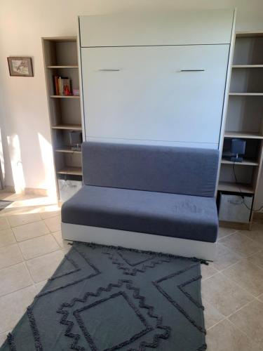 a bed sitting on the floor in a room at La Bouillerie du Manoir des Bréholles in Goustranville