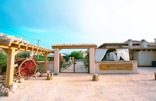 a building with a red wheel and a pavilion at Hotel Don Marcos in Osma