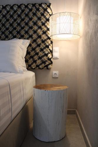 a bedroom with a bed and a table with a lamp at elia boutique hotel in Parga