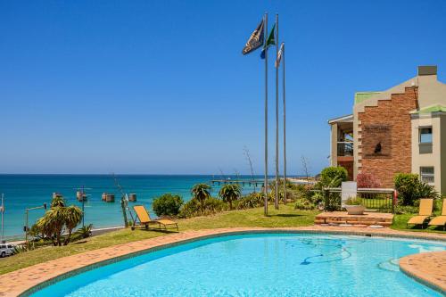 a swimming pool with a view of the ocean at Brookes Hill Suites Luxury Apartment 124 in Port Elizabeth