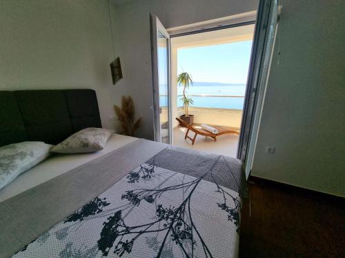 um quarto com uma cama e vista para a praia em Apartments Gabriela em Drasnice