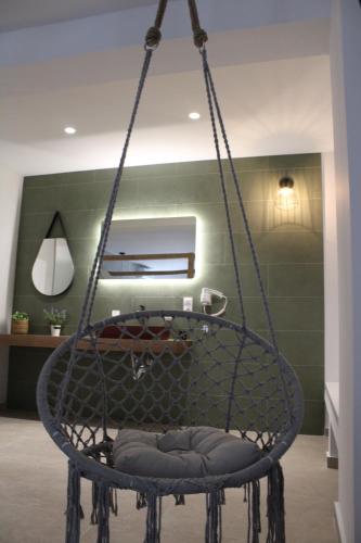 a hanging chair in a room with at elia boutique hotel in Parga