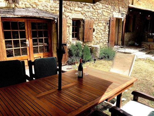 a bottle of wine sitting on a wooden table at Weekend en Provence in Comps
