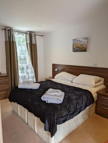 a bedroom with a bed with two towels on it at Barley Sheaf, Old Bridge Street EN SUITE ROOMS, ROOM ONLY in Truro