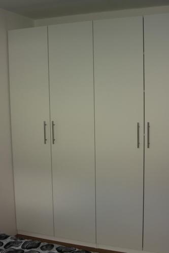a group of four white cabinets in a room at Alpendomizil Pia in Mühlbach am Hochkönig