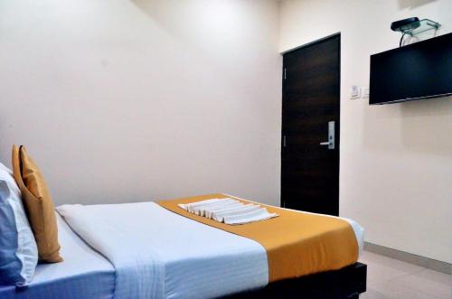 a room with a bed and a flat screen tv at THE BEST HOTEL MUMBAI in Mumbai