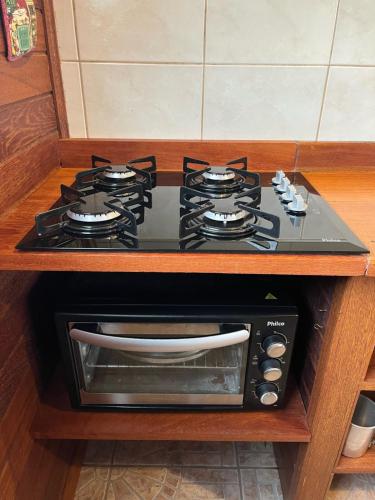 a stove top oven sitting on top of a counter at La Tatuira, Cabana Amarela in Pinheira