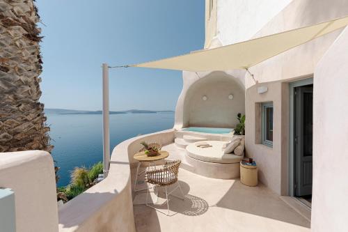 a patio with a view of the water at The Exotic Cave Suite in Oia