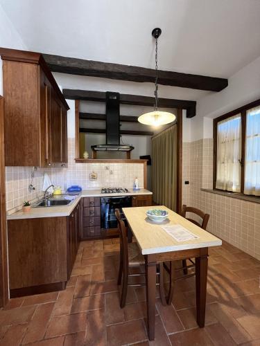 a kitchen with a table and a dining room at Agriturismo Il Gonzeto, Montepulciano in Montepulciano